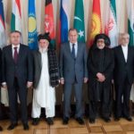 Why do Russia and ally Tajikistan hold divurgent positions regarding the Taliban?